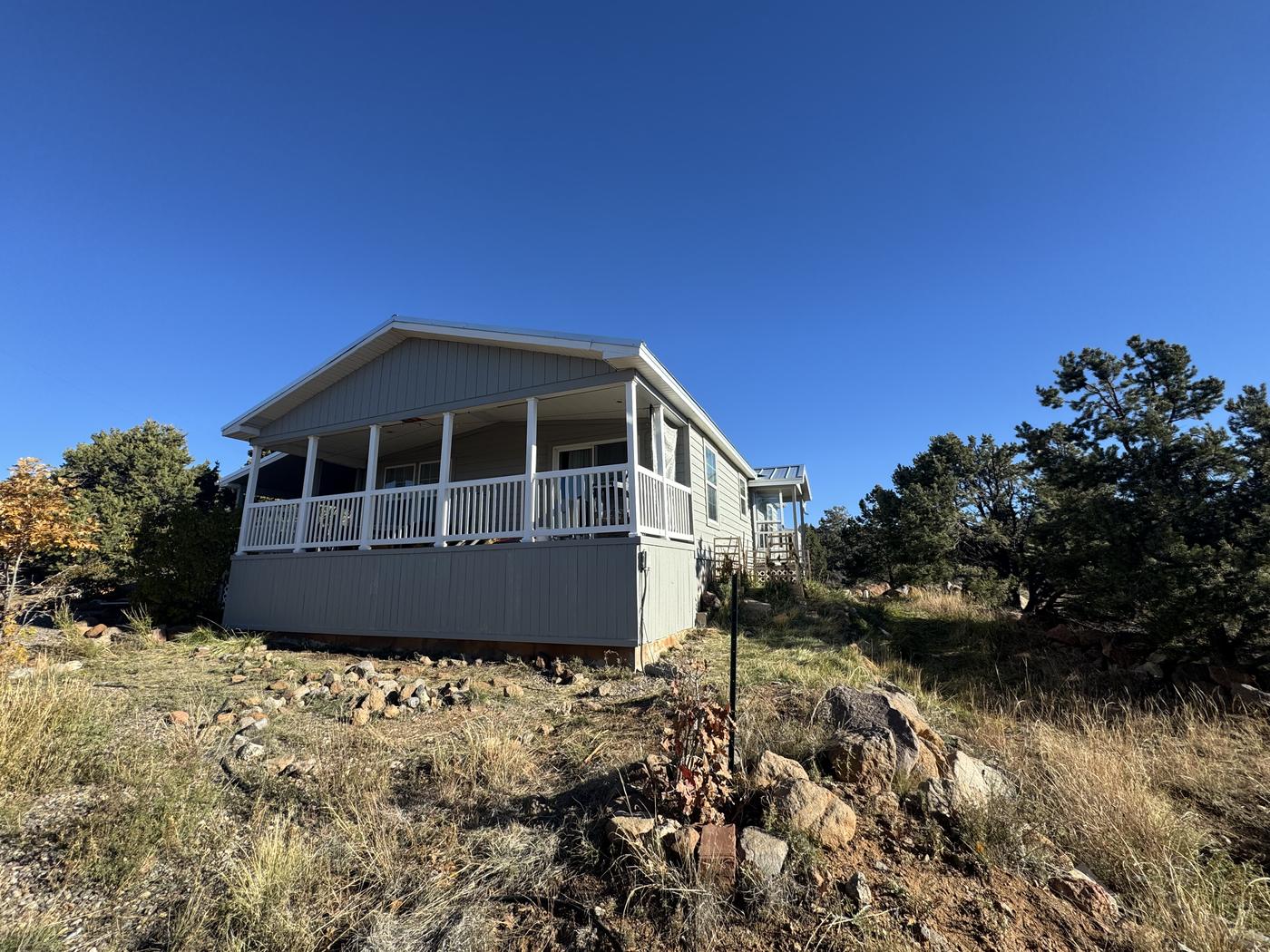 Hillside home with freshly painted porch and exterior