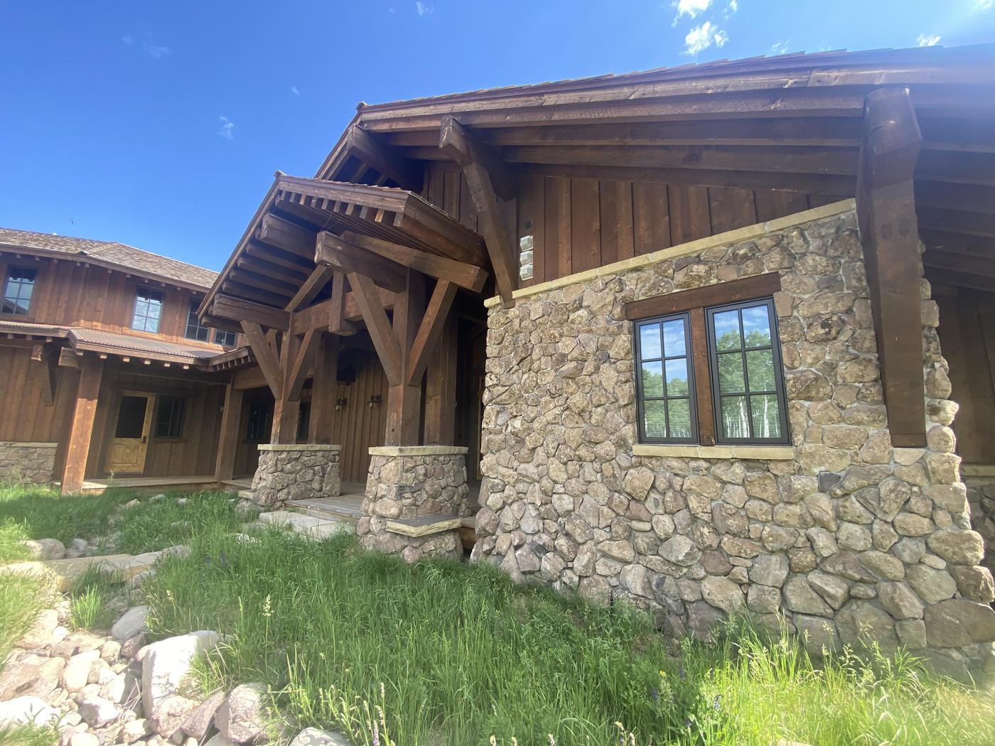 Stone and timber lodge with fresh exterior finish